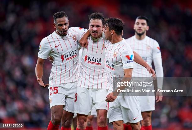 Thomas Delaney of Sevilla FC celebrates with his teammate Fernando Reges and Oliver Torres Munoz of Sevilla FC after scoring the opening goal during...