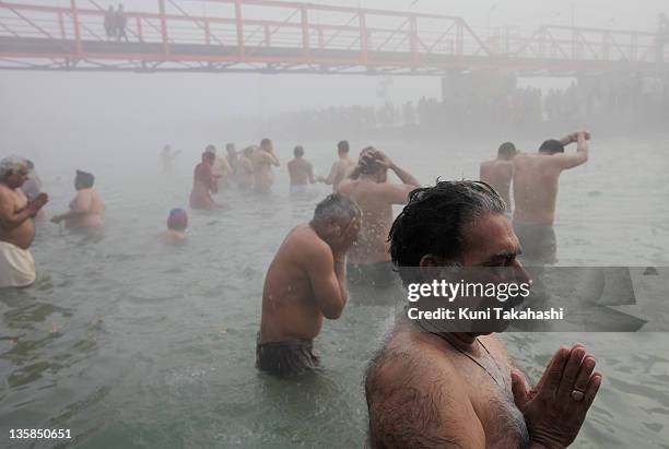 Pilgrims bathe in holy Ganges River during Kumbh Mela, largest Hindu gathering in the world, January 15, 2010 in Haridwar, India. Hindus believe that...