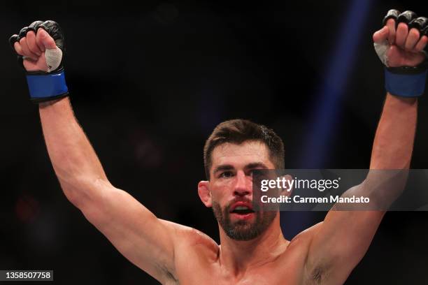 Dominick Cruz celebrates after his unanimous decision victory over Pedro Munhoz of Brazil in their bantamweight fight during the UFC 269 event at...