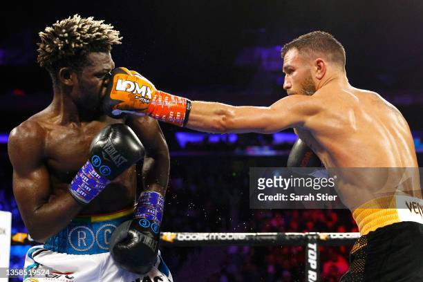 Vasiliy Lomachenko trades punches with Richard Commey during their WBO Intercontinental Lightweight Title fight at Madison Square Garden on December...