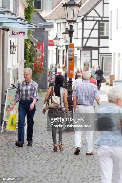 pedestrians are walking in altstadt of essen werden - senior essen stockfoto's en -beelden