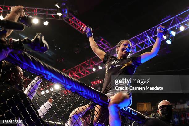 Julianna Pena celebrates after defeating Amanda Nunes of Brazil to win the women's bantamweight title during the UFC 269 event at T-Mobile Arena on...