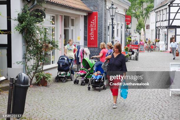 woman with shopping bags and women with baby buggies - essen germany imagens e fotografias de stock