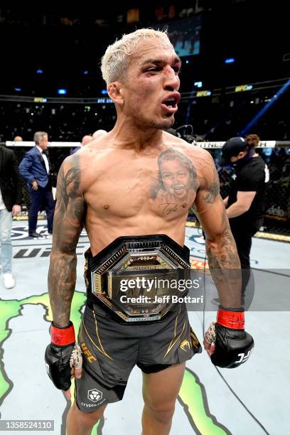 Charles Oliveira of Brazil reacts after being announced the winner by submission against Dustin Poirier after their UFC lightweight championship bout...