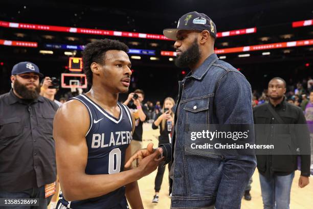 Bronny James of the Sierra Canyon Trailblazers is greeted by his father and NBA player LeBron James after defeating the the Perry Pumas in the...