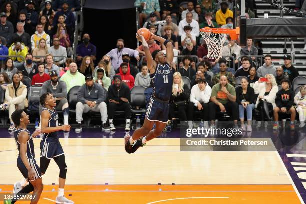 Kijani Wright of the Sierra Canyon Trailblazers slam dunks the ball against the Perry Pumas during the Hoophall West tournament at Footprint Center...