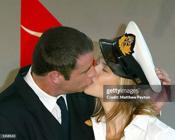 Actor John Travolta kisses wife Kelly Travolta after arriving in their Quantas 707 "Jett Clipper Ella" on the final stop of his round the globe...