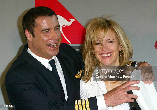 Actor John Travolta laugh with wife Kelly Travolta after arriving in their Quantas 707 "Jett Clipper Ella" on the final stop of his round the globe...