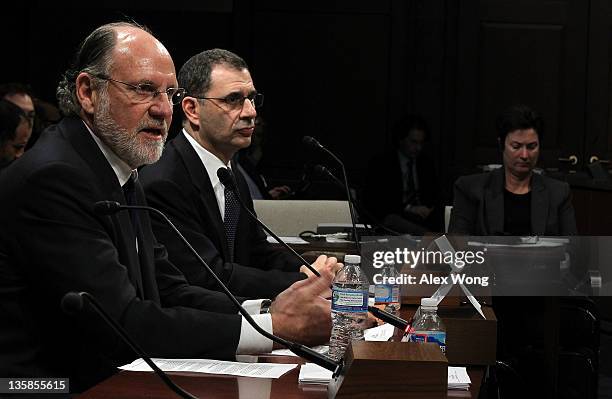 Former chairman and CEO of MF Global and former New Jersey Governor Jon Corzine and COO of MF Global Bradley Abelow testify during a hearing before...