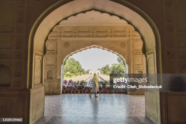 woman in hijab  walking in mosque - pakistan culture stock pictures, royalty-free photos & images