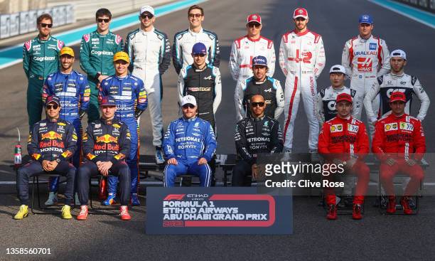 The F1 Drivers pose for an end of season picture on the grid prior to the F1 Grand Prix of Abu Dhabi at Yas Marina Circuit on December 12, 2021 in...