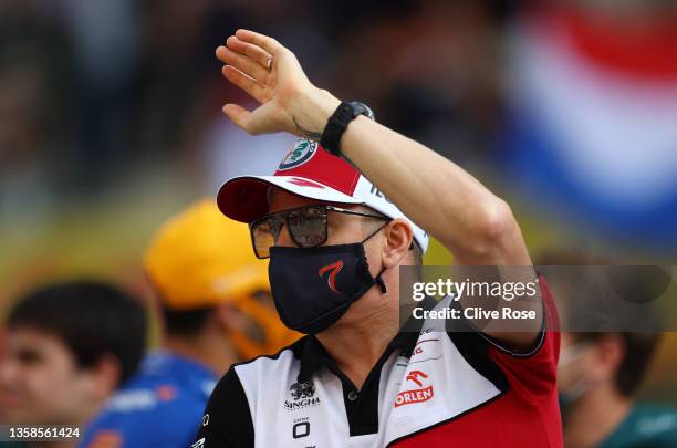 Kimi Raikkonen of Finland and Alfa Romeo Racing waves to fans during the F1 drivers parade prior to the F1 Grand Prix of Abu Dhabi at Yas Marina...