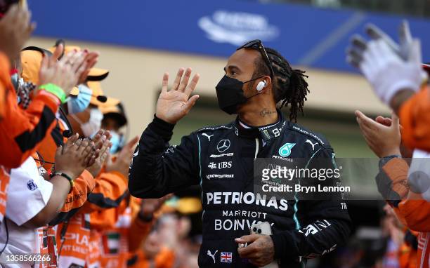Lewis Hamilton of Great Britain and Mercedes GP walks out to the F1 drivers parade ahead of the F1 Grand Prix of Abu Dhabi at Yas Marina Circuit on...