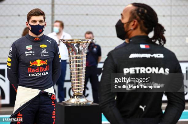 Championship contenders Max Verstappen of Netherlands and Red Bull Racing and Lewis Hamilton of Great Britain and Mercedes GP stand in front of the...