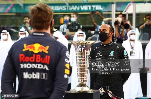 Championship contenders Max Verstappen of Netherlands and Red Bull Racing and Lewis Hamilton of Great Britain and Mercedes GP stand in front of the...