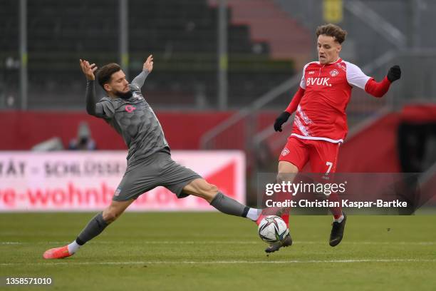 Mirnes Pepic of FC Wuerzburger Kickers is tackled by Can Coskun of FSV Zwickau during the 3. Liga match between Würzburger Kickers and FSV Zwickau at...