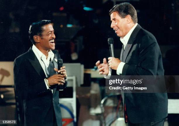 Actor Jerry Lewis performs with singer Sammy Davis Jr. During the 1976 telecast of The Jerry Lewis MDA Telethon in Los Angeles, California. This...