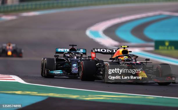 Sergio Perez of Mexico driving the Red Bull Racing RB16B Honda leads Lewis Hamilton of Great Britain driving the Mercedes AMG Petronas F1 Team...