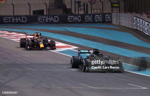 Lewis Hamilton of Great Britain driving the Mercedes AMG Petronas F1 Team Mercedes W12 leads Max Verstappen of the Netherlands driving the Red Bull...