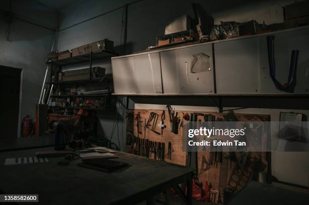 workbench in low light shadow from window - trestles stockfoto's en -beelden