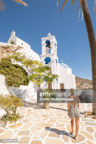 young woman strolling in the narrow greek alleys - ios greece stock pictures, royalty-free photos & images