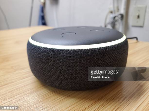 Close-up of Amazon Echo Dot third generation smart speaker with Alexa on light wooden surface, Lafayette, California, December 4, 2021. Photo...