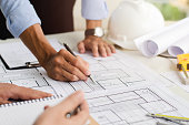 Close-up of an engineer planning a hand-drawn design. with architect equipment Architects talking at the table Teamwork and workflow concepts