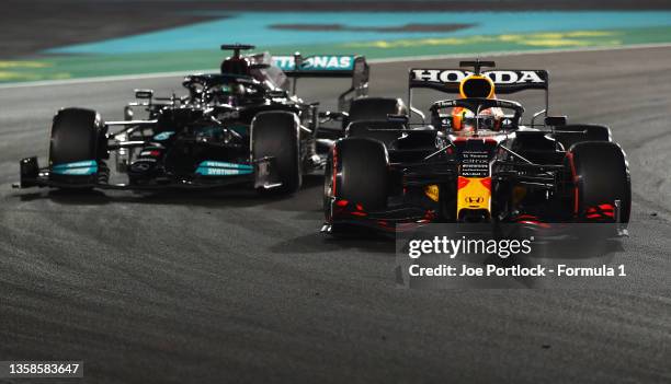 Max Verstappen of the Netherlands driving the Red Bull Racing RB16B Honda overtakes Lewis Hamilton of Great Britain driving the Mercedes AMG Petronas...