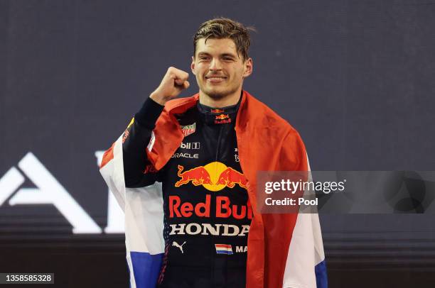 Race winner and 2021 F1 World Drivers Champion Max Verstappen of Netherlands and Red Bull Racing celebrates on the podium during the F1 Grand Prix of...