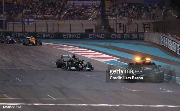 The FIA Safety Car leads Lewis Hamilton of Great Britain driving the Mercedes AMG Petronas F1 Team Mercedes W12 and the rest of the field during the...