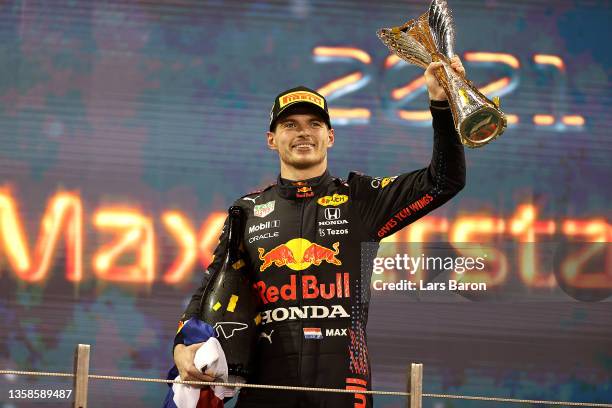 Race winner and 2021 F1 World Drivers Champion Max Verstappen of Netherlands and Red Bull Racing celebrates on the podium during the F1 Grand Prix of...