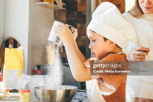 small boy cooking at home. - kid chef stock pictures, royalty-free photos & images