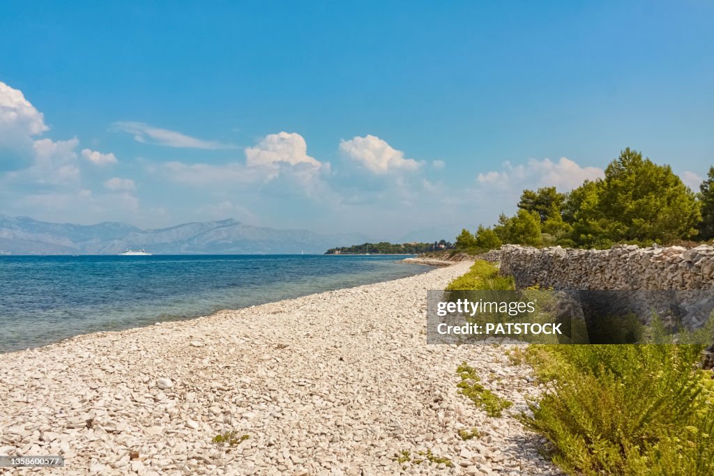Pebble beach by the Adriatic Sea in Mirca village, Brac Island, Croatia.
