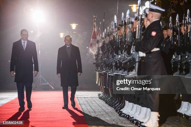 Polish Prime Minister Mateusz Morawiecki greets German Chancellor Olaf Scholz upon Scholz's arrival at the Prime Minister Chancellery on December 12,...