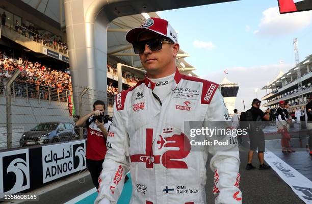 Kimi Raikkonen of Finland and Alfa Romeo Racing walks on the grid prior to the F1 Grand Prix of Abu Dhabi at Yas Marina Circuit on December 12, 2021...