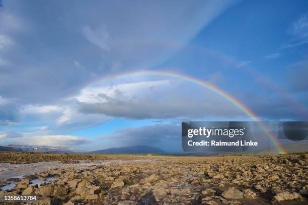 glacier river flows through basalt landscape with rainbow, husafell, kaldidalur, nordurland vestra, iceland - kaldidalur stock pictures, royalty-free photos & images