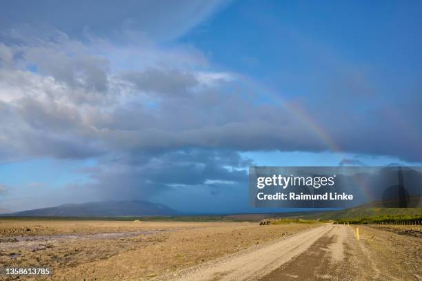 glacier river flows through basalt landscape with rainbow, husafell, kaldidalur, nordurland vestra, iceland - kaldidalur stock pictures, royalty-free photos & images