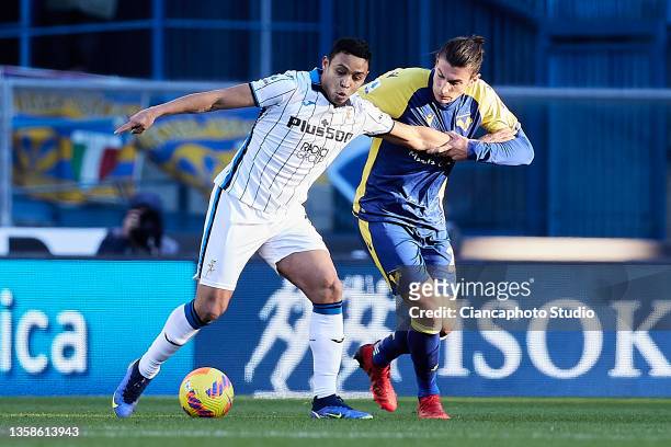 Luis Muriel of Atalanta competes for the ball with Giangiacomo Magnani of Hellas Verona FC during the Serie A match between Hellas Verona and...