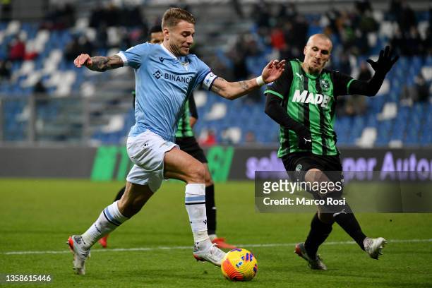 Ciro Immobile of SS Lazio compete for the ball with Vlad Chiriches of US Sssuolo during the Serie A match between US Sassuolo and SS Lazio at Mapei...
