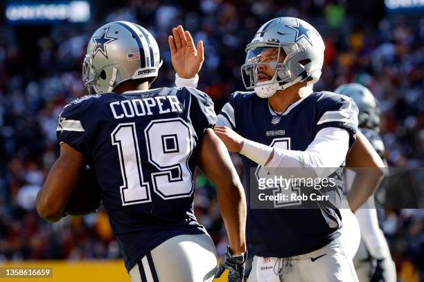 Dak Prescott of the Dallas Cowboys celebrates with Amari Cooper after a seven-yard touchdown pass against the Washington Football Team during the...