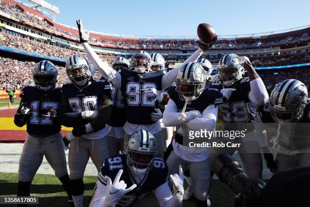 Dorance Armstrong of the Dallas Cowboys celebrates with teammates after returning a fumble for a touchdown during the first quarter against the...
