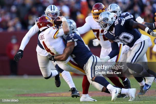Micah Parsons of the Dallas Cowboys forces Taylor Heinicke of the Washington Football Team to fumble and is returned for a touchdown by Dorance...