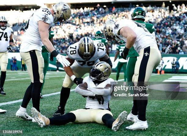 Alvin Kamara of the New Orleans Saints celebrates his rushing touchdown with teammates during the second quarter against the New York Jets at MetLife...