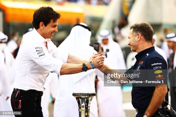 Mercedes GP Executive Director Toto Wolff and Red Bull Racing Team Principal Christian Horner shake hands on the grid before the F1 Grand Prix of Abu...