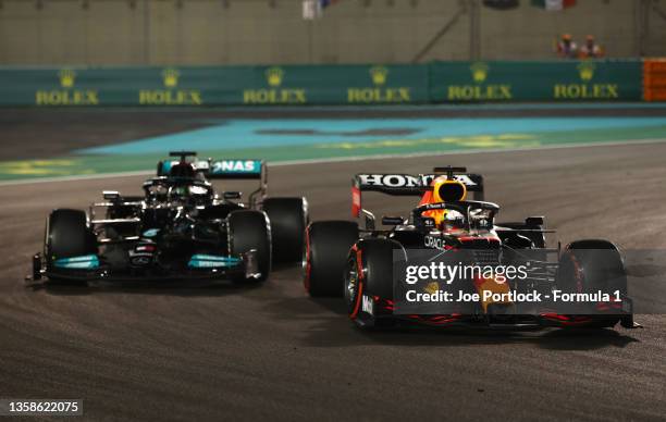 Max Verstappen of the Netherlands driving the Red Bull Racing RB16B Honda overtakes Lewis Hamilton of Great Britain driving the Mercedes AMG Petronas...