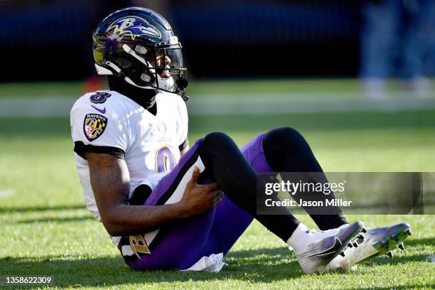 Lamar Jackson of the Baltimore Ravens stays down on the field after suffering an injury in the first half against the Cleveland Browns at FirstEnergy...