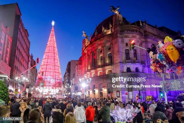 Group of people watch the Christmas lighting after several days of rain, on 12 December, 2021 in Vigo, Galicia, Spain. The State Meteorological...