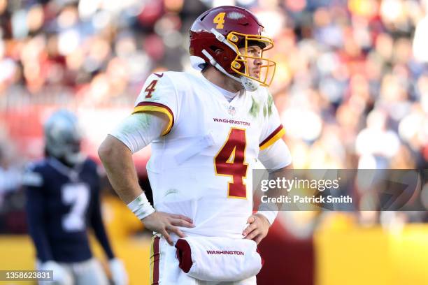 Taylor Heinicke of the Washington Football Team reacts against the Dallas Cowboys during the second quarter at FedExField on December 12, 2021 in...