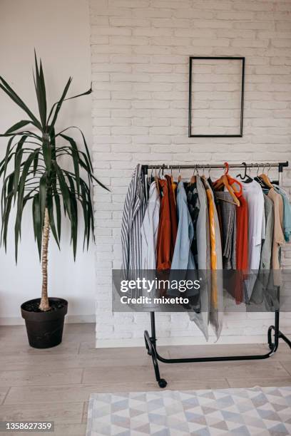 modern bedroom with clothes rack - menswear stock pictures, royalty-free photos & images