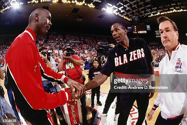 Clyde Drexler of the Portland Trail Blazers shakes hands with Michael Jordan of the Chicago Bulls prior to playing game 3 of the1992 NBA Finals at...